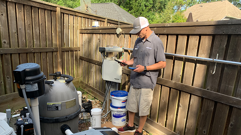 technician completing a pool equipment checkup